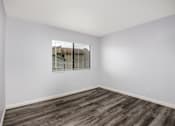 Thumbnail 51 of 53 - A room with wooden flooring and a window with blinds.