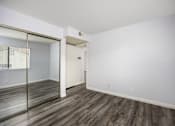Thumbnail 48 of 53 - A room with a sliding glass door and wood flooring.
