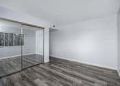 Thumbnail 52 of 53 - A room with a sliding glass door and wood flooring.