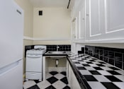 Thumbnail 10 of 18 - a kitchen with black and white checkered floors and a white stove and sink