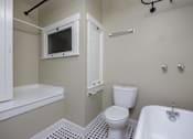 Thumbnail 15 of 18 - a bathroom with a toilet and a bath tub and a sink