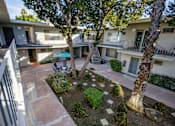 Thumbnail 8 of 28 - a view of the courtyard of a building with trees