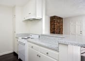 Thumbnail 23 of 28 - an empty kitchen with white appliances and granite counter tops