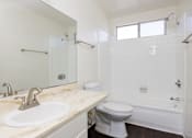 Thumbnail 24 of 28 - a bathroom with a sink toilet and a shower