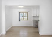 Thumbnail 22 of 41 - a living room with white walls and a window