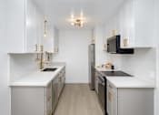 Thumbnail 23 of 41 - a kitchen with white cabinets and stainless steel appliances