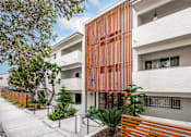 Thumbnail 3 of 63 - A modern building with a white and orange facade.