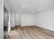 Thumbnail 46 of 63 - A room with wooden flooring and white walls.