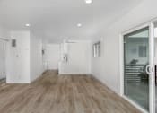 Thumbnail 48 of 63 - A room with wooden flooring and white walls.