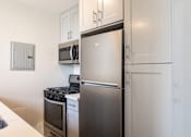 Thumbnail 13 of 45 - a kitchen with stainless steel appliances and a refrigerator