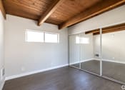 Thumbnail 15 of 45 - an empty living room with sliding glass doors to a closet