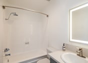 Thumbnail 20 of 45 - a bathroom with a shower and a sink and a mirror