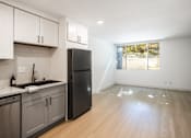 Thumbnail 12 of 45 - an empty kitchen with stainless steel appliances and a window
