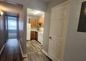 Thumbnail 3 of 29 - A kitchen with white appliances and wooden cabinets.