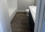 Thumbnail 22 of 29 - A small bathroom with a toilet, sink, and bathtub.