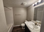 Thumbnail 28 of 29 - A white sink is on a marble countertop in a small bathroom.