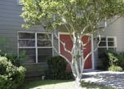 Thumbnail 13 of 20 - a house with a red door and a tree in front of it
