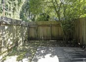 Thumbnail 16 of 20 - a backyard with a wooden fence and a tree