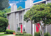 Thumbnail 5 of 20 - a gray apartment building with red doors