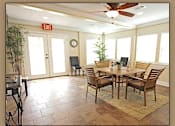 Thumbnail 3 of 10 - A dining room with a table and chairs.