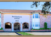 Thumbnail 1 of 7 - A building with the sign Northshore Villas 4802 on it.
