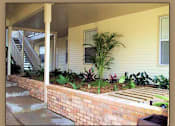 Thumbnail 7 of 7 - A house with a staircase and a wall of plants.