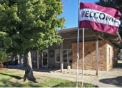 Thumbnail 2 of 20 - a building with a flag in front of it