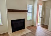 Thumbnail 9 of 20 - a living room with a fireplace and a hard wood floor