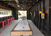 Thumbnail 11 of 24 - A long table with a bench in the middle of it.