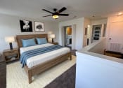 Thumbnail 4 of 20 - a bedroom with a bed and a ceiling fan