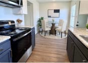 Thumbnail 3 of 20 - a kitchen and dining room with a table and chairs
