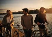 Thumbnail 7 of 20 - a group of people standing next to a body of water