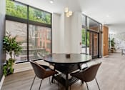 Thumbnail 43 of 57 - A modern dining room with a large table and chairs.
