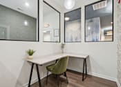 Thumbnail 48 of 57 - A white desk with a green chair in front of a mirrored wall.