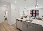 Thumbnail 2 of 24 - Kitchen and living room with white walls and a wooden floor  at The Anchorage on Kelly, Pennsylvania