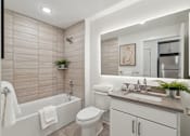 Thumbnail 26 of 57 - A bathroom with a white tub, toilet, and sink.