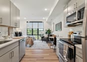 Thumbnail 14 of 57 - A modern kitchen with a large island and stainless steel appliances.