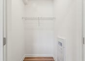 Thumbnail 30 of 57 - A white wall with a shelf and a door.