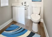 Thumbnail 9 of 25 - a bathroom with a toilet sink and mirror