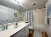Thumbnail 9 of 37 - a bathroom with a sink and a toilet and a shower