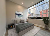 Thumbnail 14 of 37 - A bedroom with a large bed and a painting on the wall.