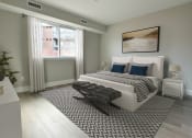 Thumbnail 5 of 25 - a bedroom with a bed and a large window