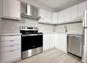 Thumbnail 4 of 25 - a kitchen with stainless steel appliances and white cabinets