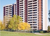 Thumbnail 10 of 11 - A large red and white building with a green lawn in front.