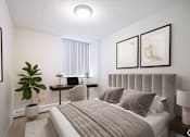 Thumbnail 3 of 11 - A bedroom with a large bed and a desk with a chair.