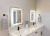 Thumbnail 11 of 15 - A white bathroom with a sink, mirror, and towel.