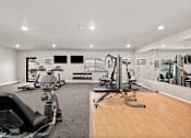 Thumbnail 19 of 28 - A gym with a variety of equipment including treadmills, weights, and exercise machines.