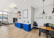 Thumbnail 3 of 28 - A room with a blue cabinet and a sign that says "First Street Lofts".