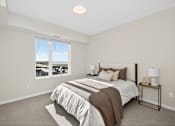 Thumbnail 13 of 19 - A bedroom with a large bed and a window overlooking a cityscape.