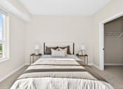 Thumbnail 12 of 19 - A bedroom with a large bed and two lamps on side tables.